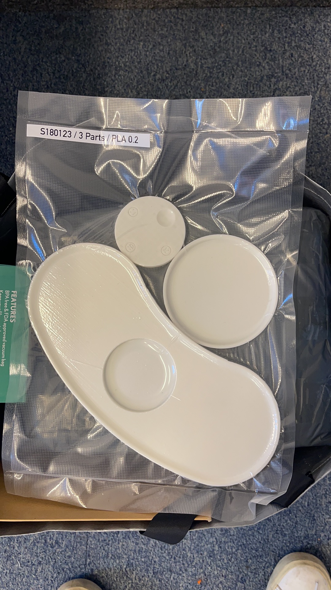 Job S180123 — three white PLA parts at 0.2mm layer height, vacuum-sealed in a labelled bag ready for client dispatch