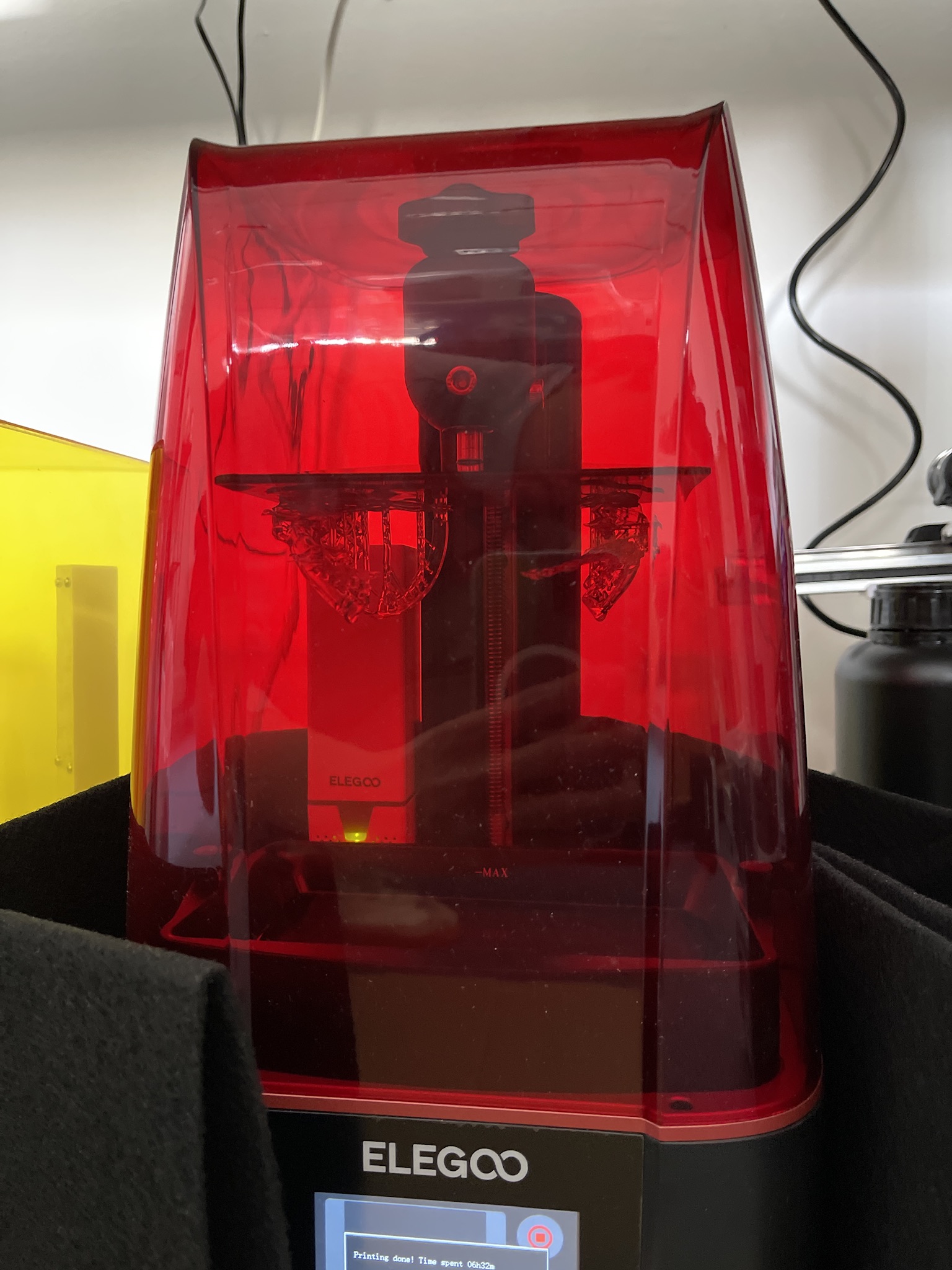 Resin (SLA/DLP) capability — Elegoo Saturn with a completed print inside, screen reading 'Printing done!'