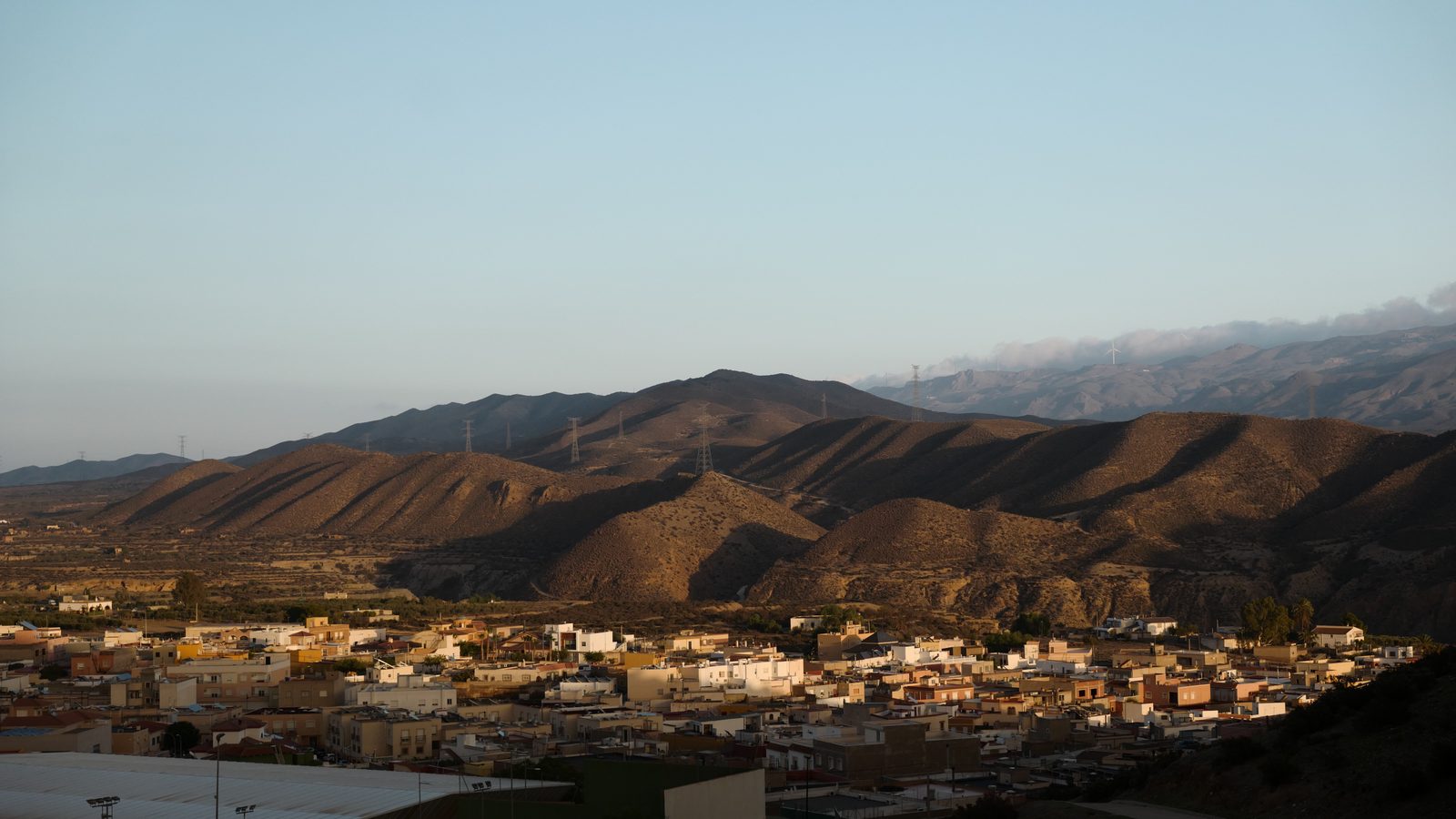 Tabernas Desert at dusk — arid mountains rising behind a small Almerían settlement
