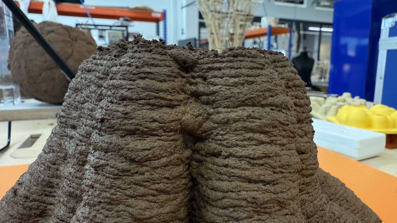 Close-up of extruded clay layers — visible stratification from the spiral toolpath